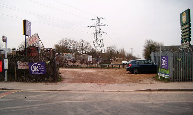 The canal entrance seen from Stoke Road in Slough, surrounded by industrial units & pylons.