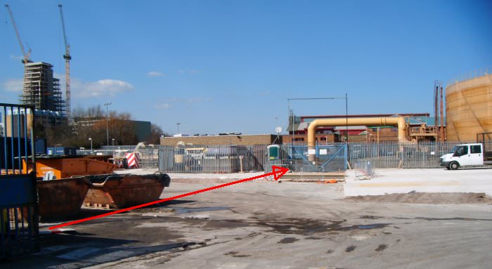 The red arrow marks the canal's former course from Armoury Way across this industrial land towards the railway DSCF0659.jpg