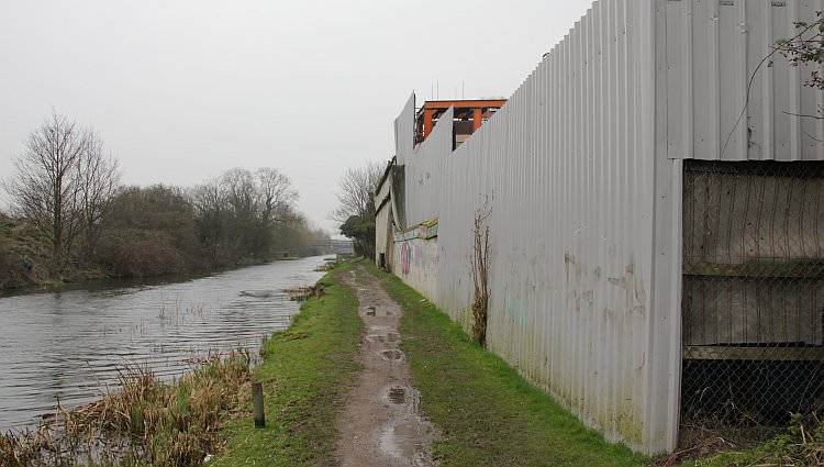 The canal passes an industrial processing plant that is accessed by lorries from nearby Trout Road